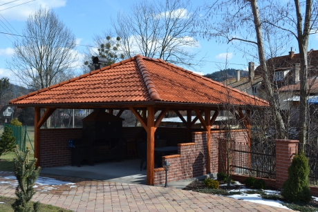 Dřevěná pergola z masivních trámú s krbem